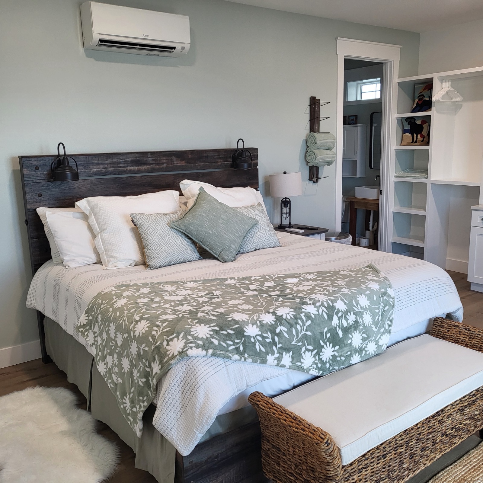 King bed and pale sea-glass interior in Unit 1